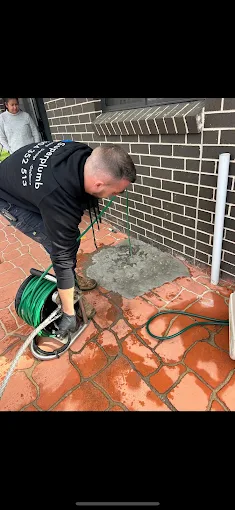 Superplumb plumber clearing an outdoor drain