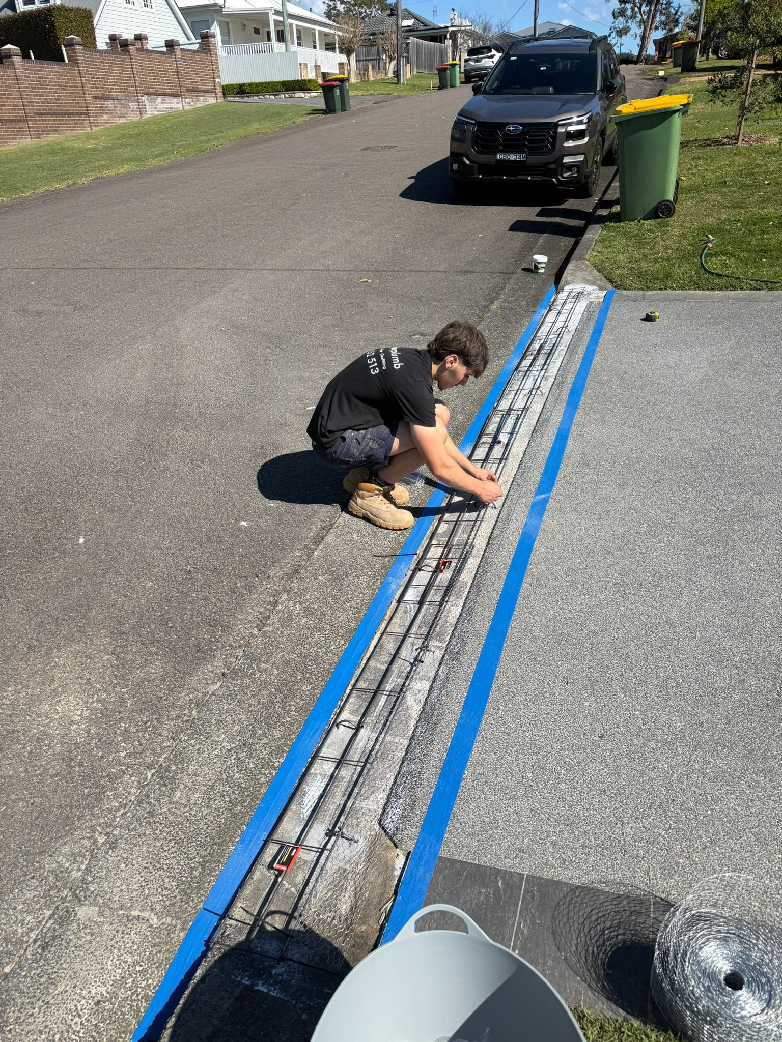 Superplumb plumber preparing driveway drainage work