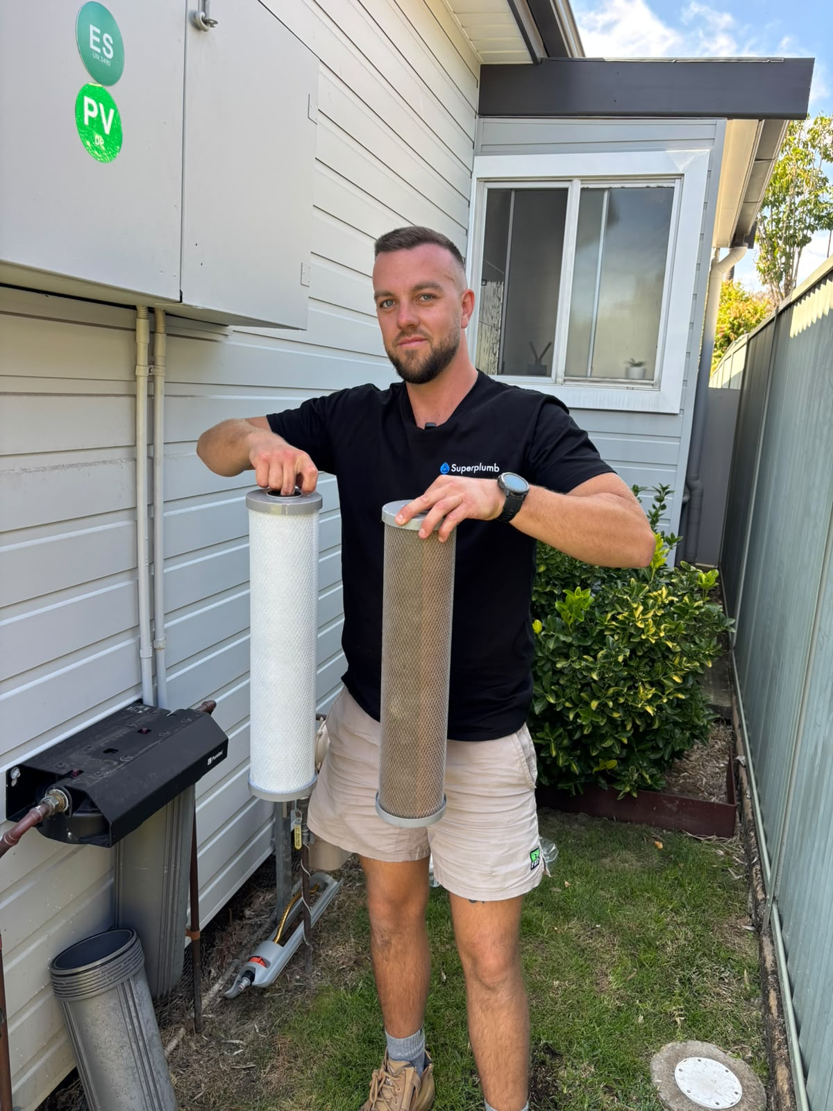 Superplumb plumber showing water filter cartridges